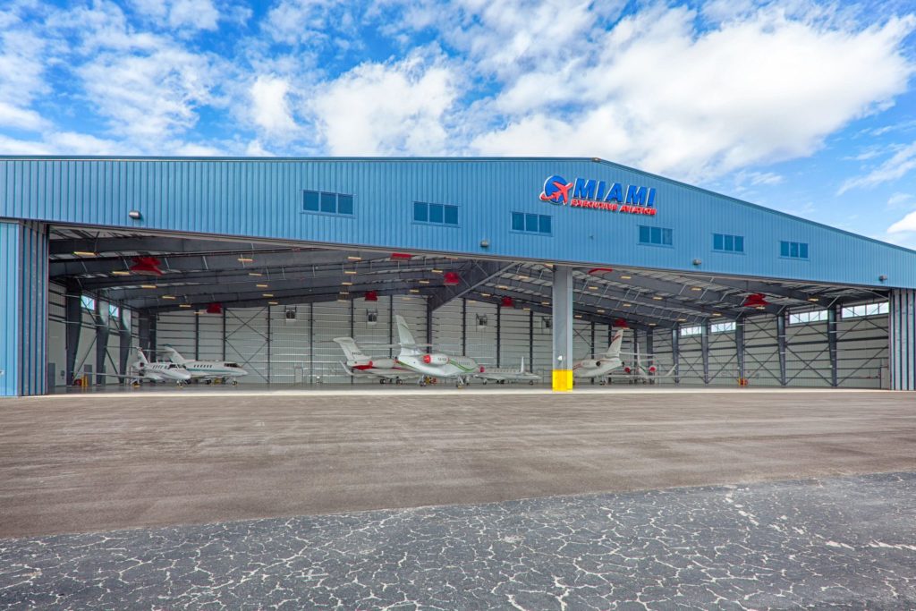 Miami Executive Aviation Hangar exterior with open doors and planes inside