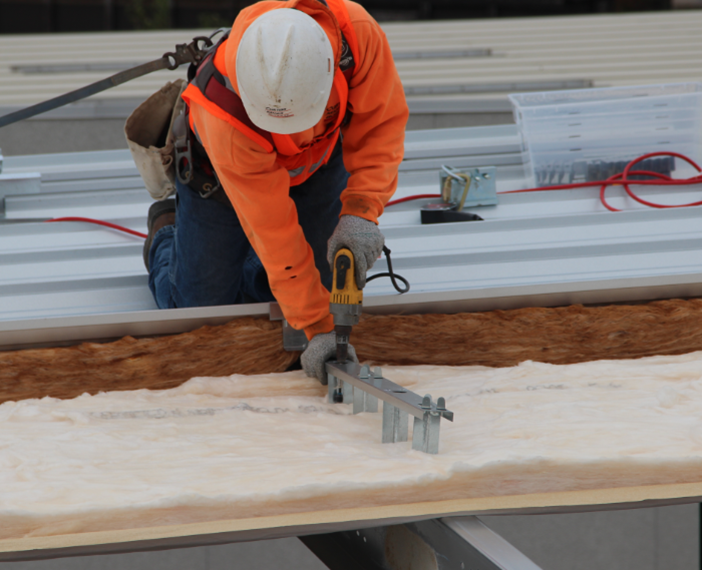 Installation of metal building insulation system