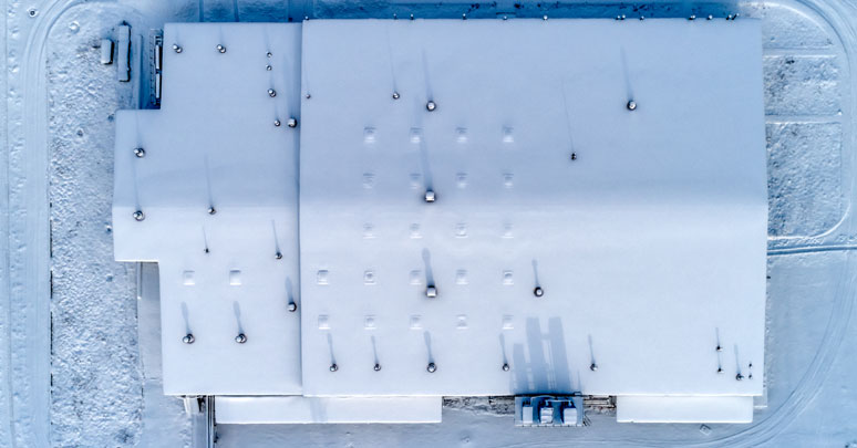 Metal building maintenance to prevent damage from snow build-up